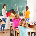 School child with teacher in classroom.
